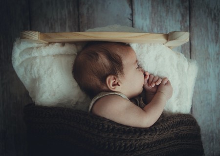 Sell back baby clothes-Sleeping baby in under a comfy warm blanket and fluffy white pillow. 