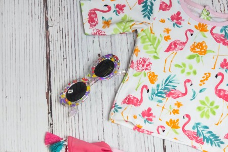 Sell back baby clothes-Swimming shirt with short sleeves and pink flamingo's and a pair of sunglasses as well.