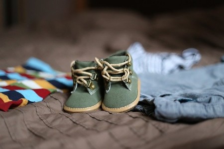 Sell back baby clothes-Baby clothing set including little green shoes.