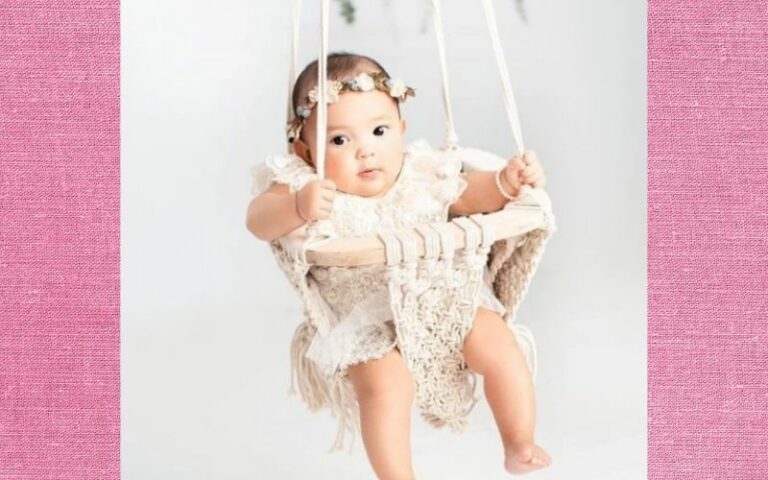 What is an infant swing?-Baby sitting in organic macramé swing.