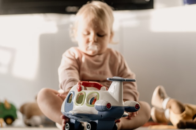 Amazon baby toys- Baby with airplane toy.