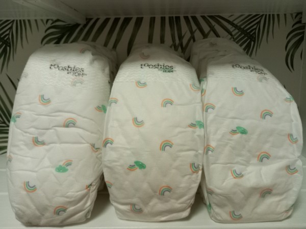 What's Tooshies by Tom?-Multiple Thoosies by Tom nappies stacked on a shelve.