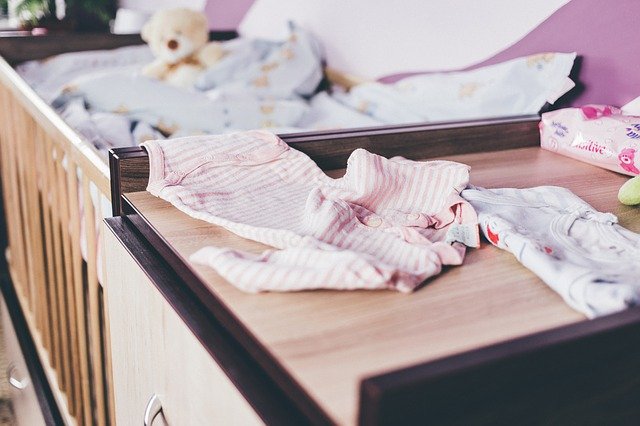Best organic cotton baby clothes in the U.S-Baby clothes spread out on a change table.