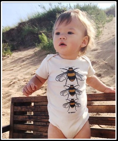 Baby wearing Bee your Self organic onesie from Soul Flower.