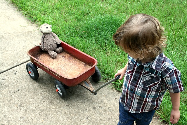 What're the Best organic stuffed animals for babies? Toddler playing outside with well used stuffed animal toy.