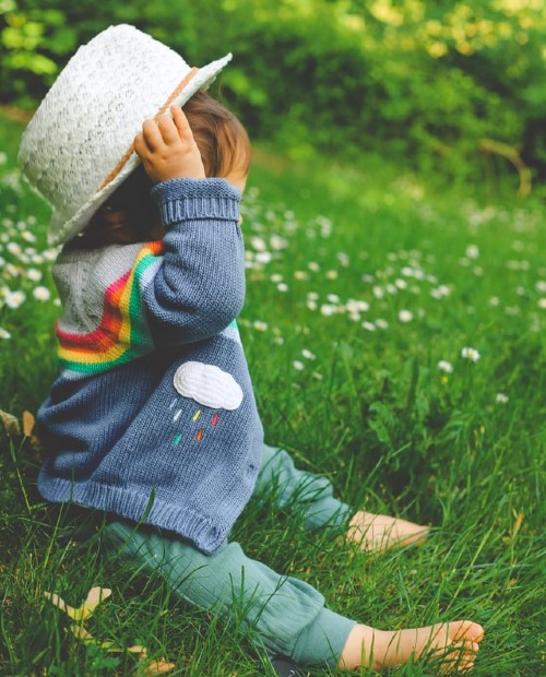 What are Boho onesies made from?-Baby dressed in BoHo style oufti sitting outside in the grass.