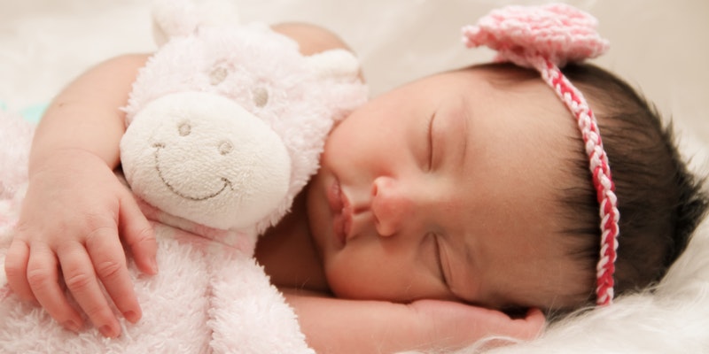What are Oeko-tex standard 100 baby clothes?-Image of sleeping baby with pink hairband.