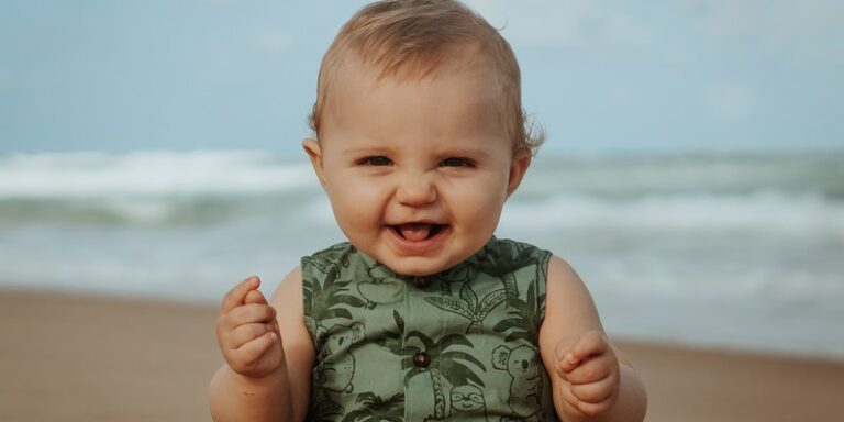 Are Bamboo baby clothes Eo-friendly?Baby on the beach smiling.