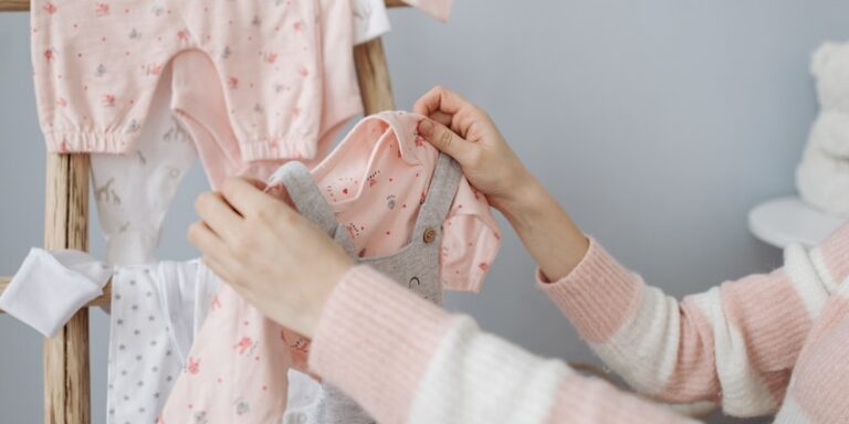 Is Bamboo fabric safe for babies?-Women holding baby clothes.