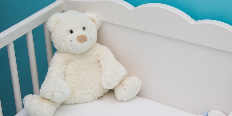 go-to stores to find a GreenGuard Gold crib Mattress.-Baby bed with white soft toy..