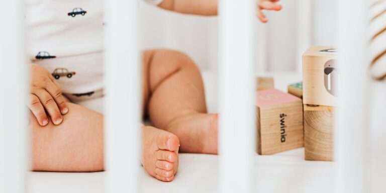 Are Nestig cribs Green Guard certified?- Image of a baby in a crib.