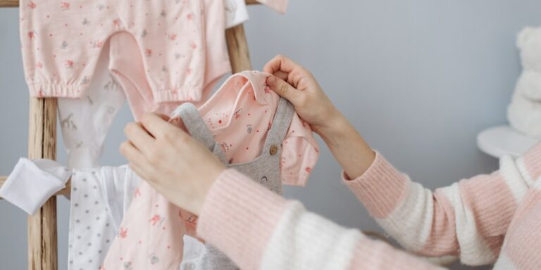 Which bamboo baby clothes brands are Oeko tex certified?-Image of person hanging baby clothes.