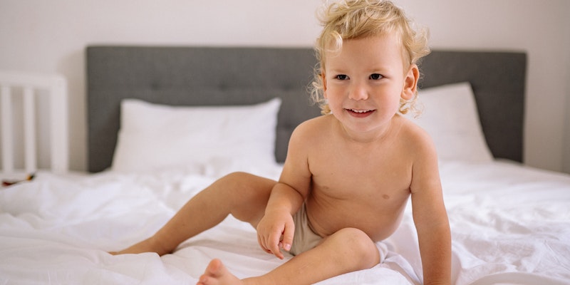 Are seventh-generation diapers biodegradable?-Happy Toddler Sitting on Bed.